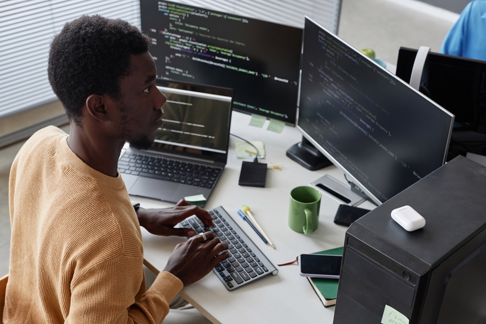 IT professional reviewing migration plans on a desktop computer for a secure IBM Notes migration.