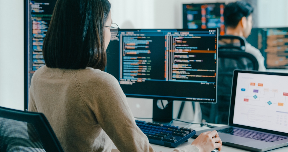 Technology specialist analyzing enterprise software during an IBM Notes migration project in a modern office environment.