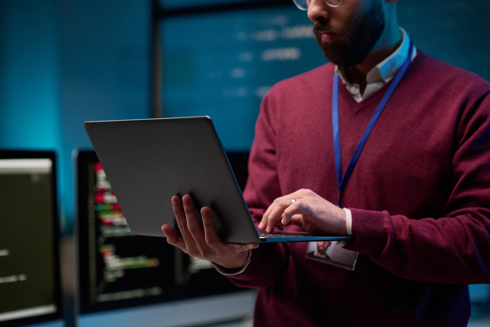 IT professional working with business applications on a laptop as part of an IBM Notes migration strategy.