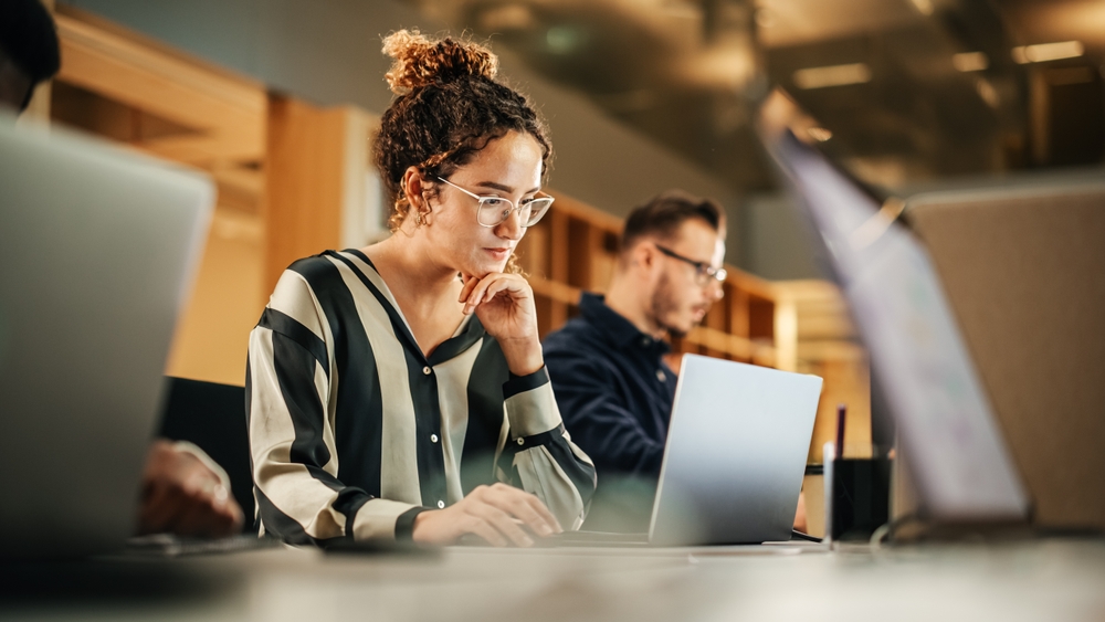 IT professional reviewing enterprise software on a laptop while managing application inventory to improve visibility across business systems.