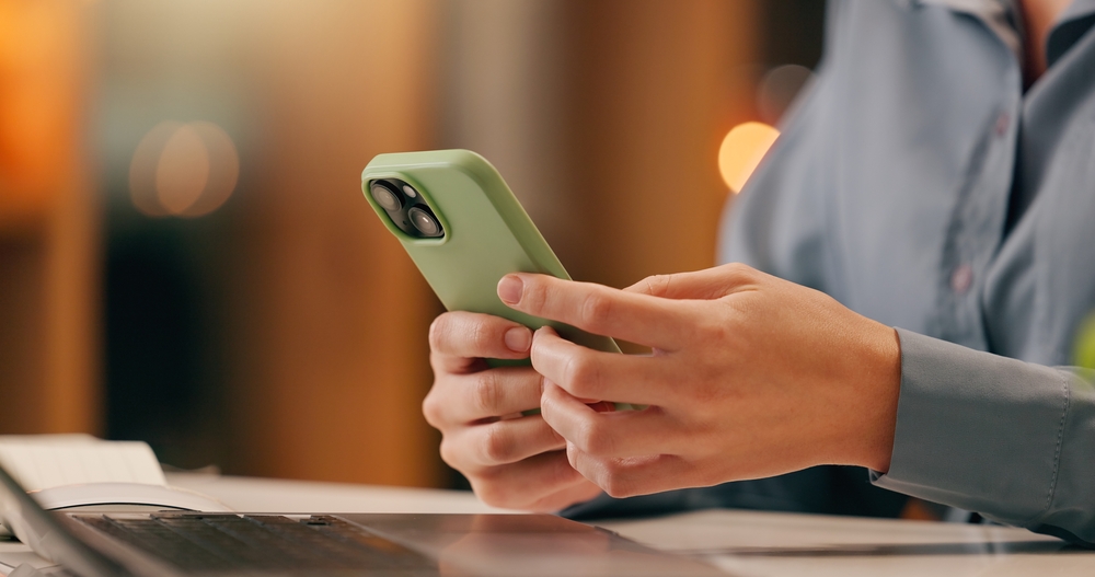 Business professional using multiple digital devices to assess application inventory and streamline enterprise application management.