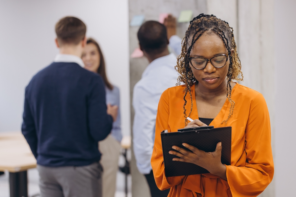 Technology specialist reviewing enterprise software on multiple screens supported by application modernization services for digital transformation.
