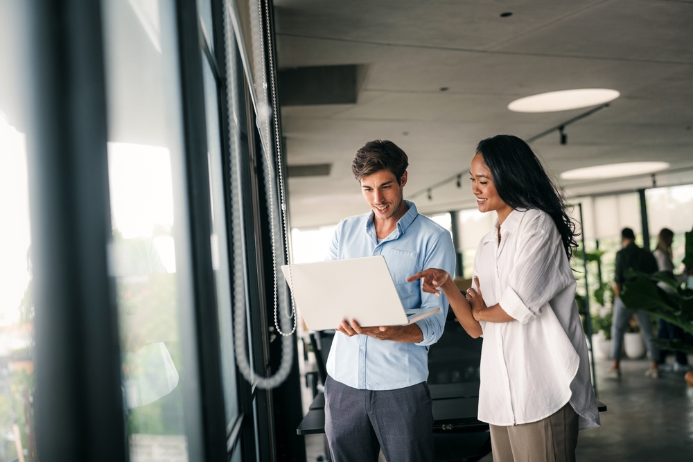 Business professional using a tablet to access modernized enterprise applications through application modernization services.
