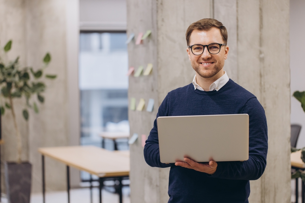 IT professional analyzing legacy application data on a laptop as part of an application modernization strategy