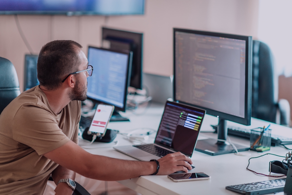 Developer reviewing legacy application code as part of an application rationalization audit
