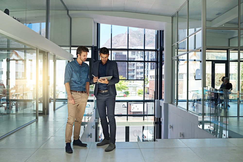 Business professional using a tablet to coordinate a project to migrate lotus domino to exchange with minimal business disruption.